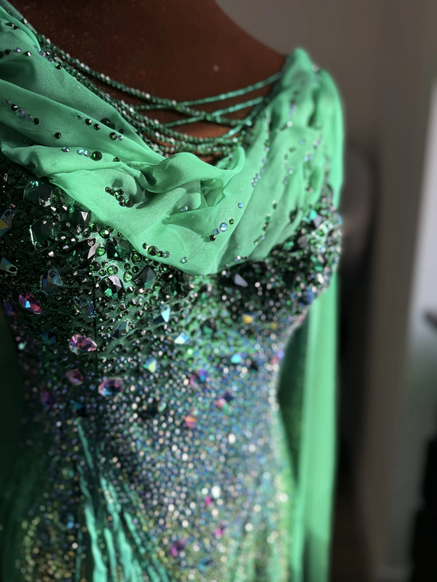Aurora neckline, draping, and rhinestone detail