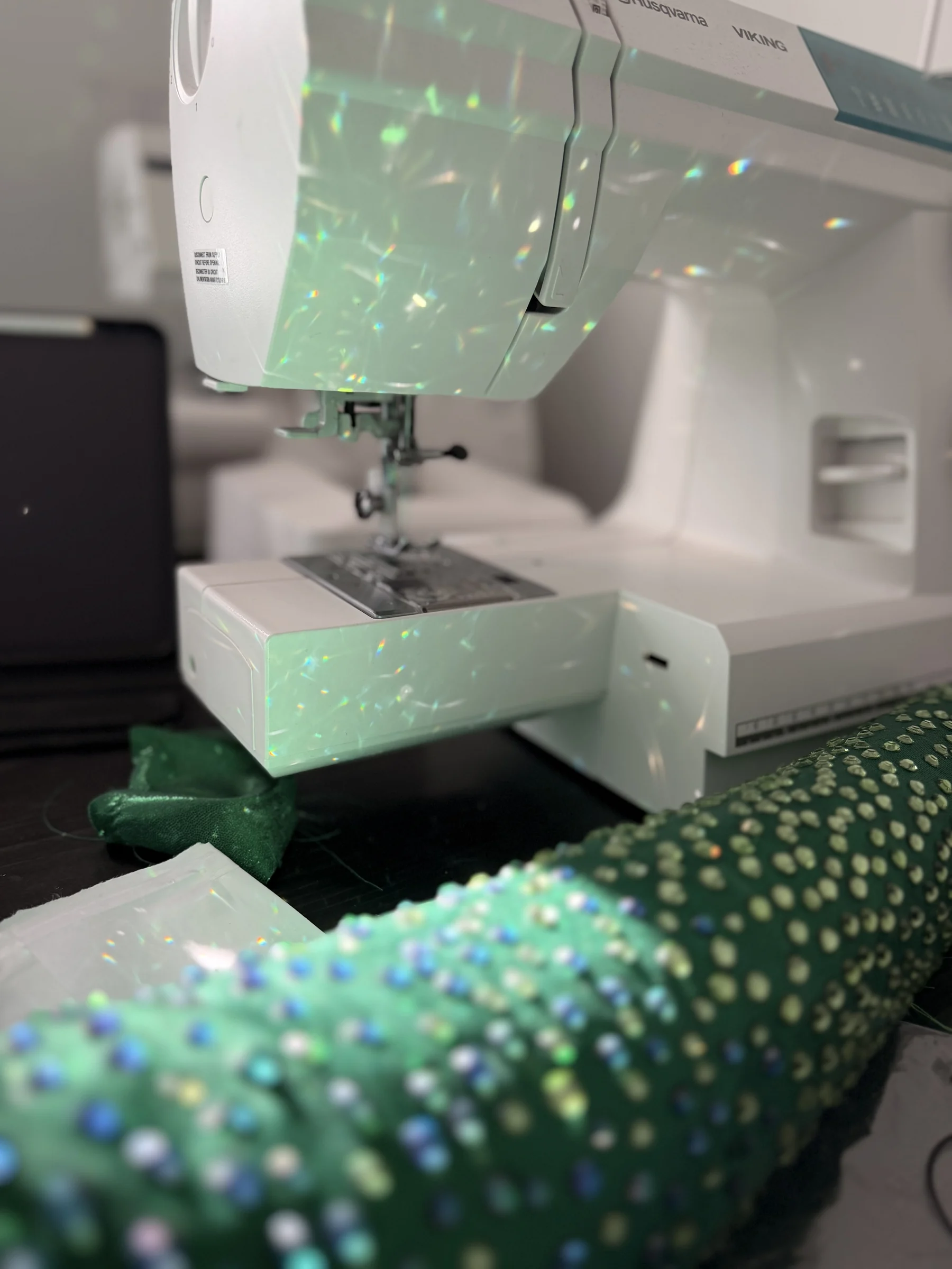 Aurora rhinestone reflections across the studio sewing machine