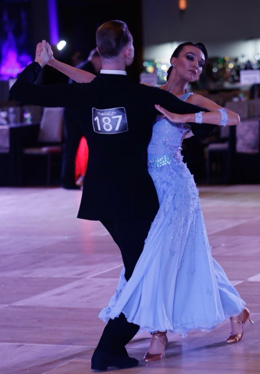 Dance couple performing with Blue Mirage in motion