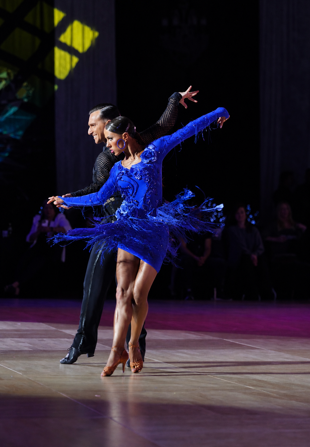 Dancer performing in a luminous blue gown