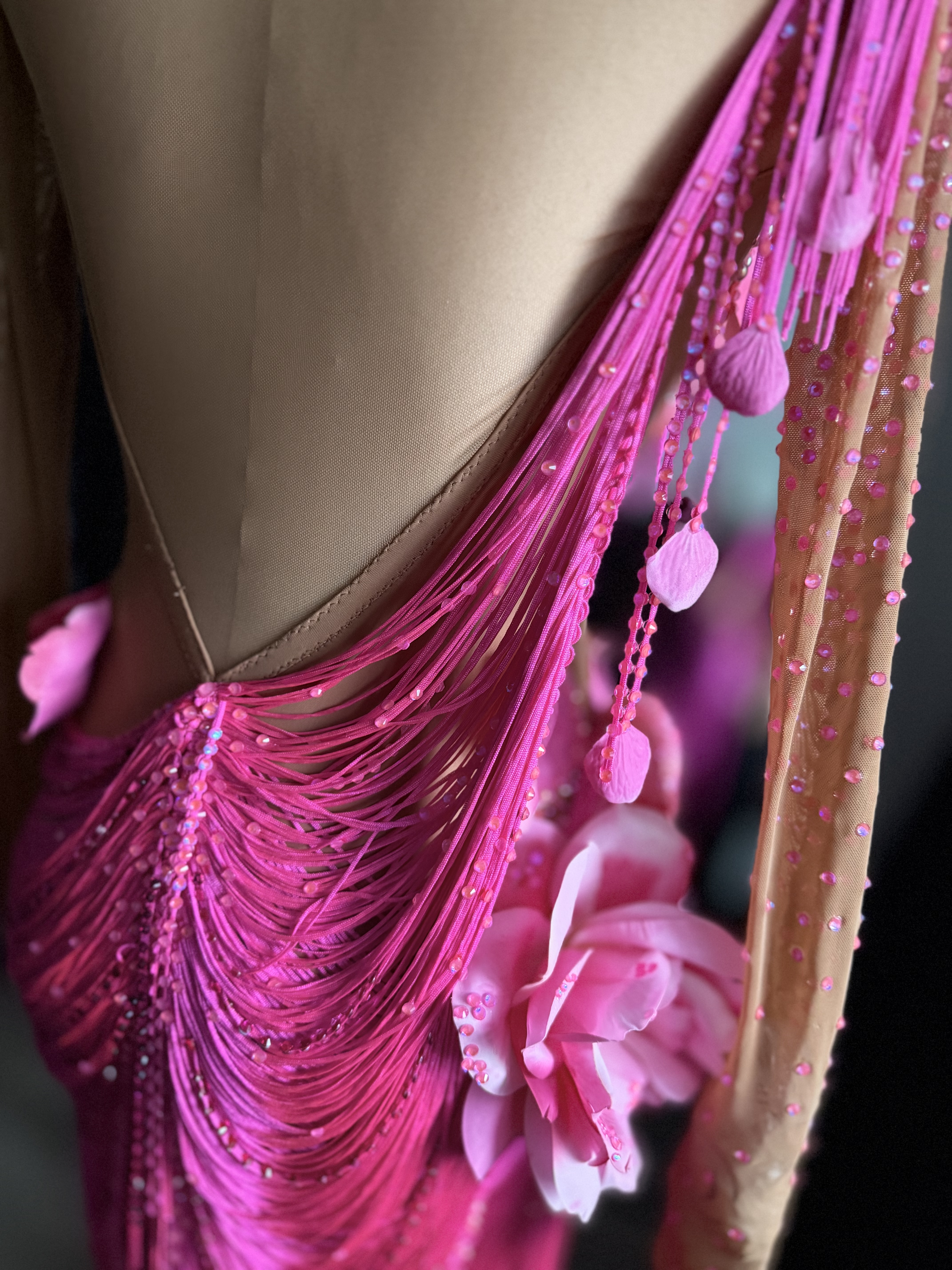 Pink fringe and flower details on the gown