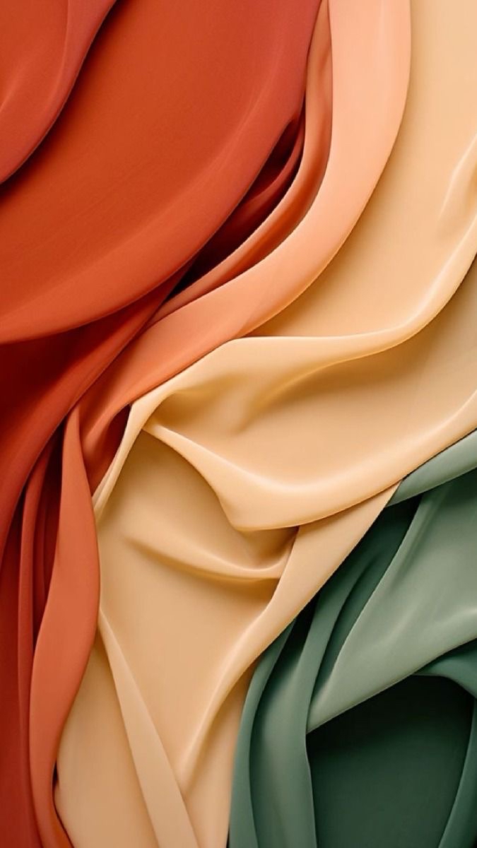 Coral, ivory, and green fabrics layered in soft folds