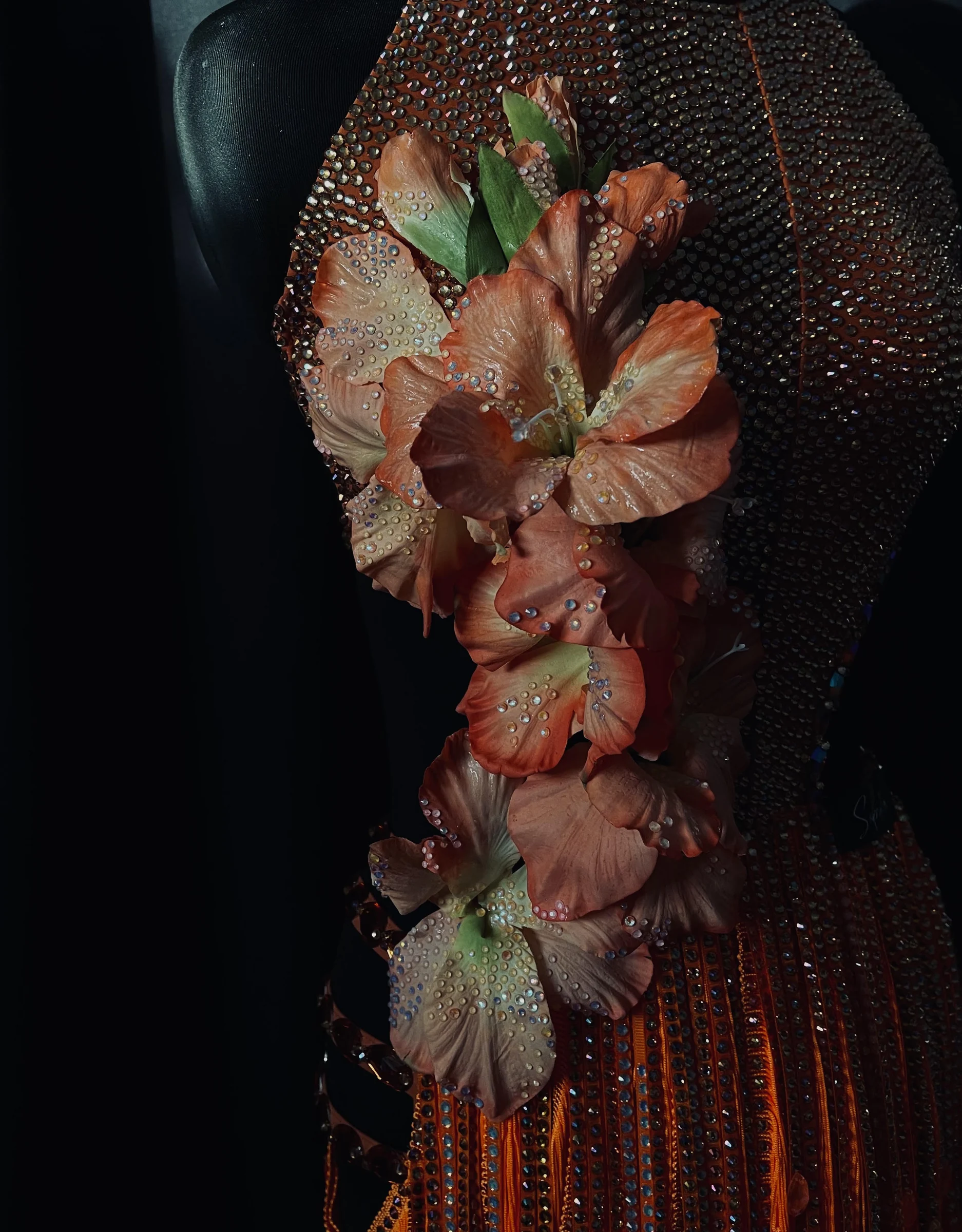 Orange couture gown with flowers and rhinestones