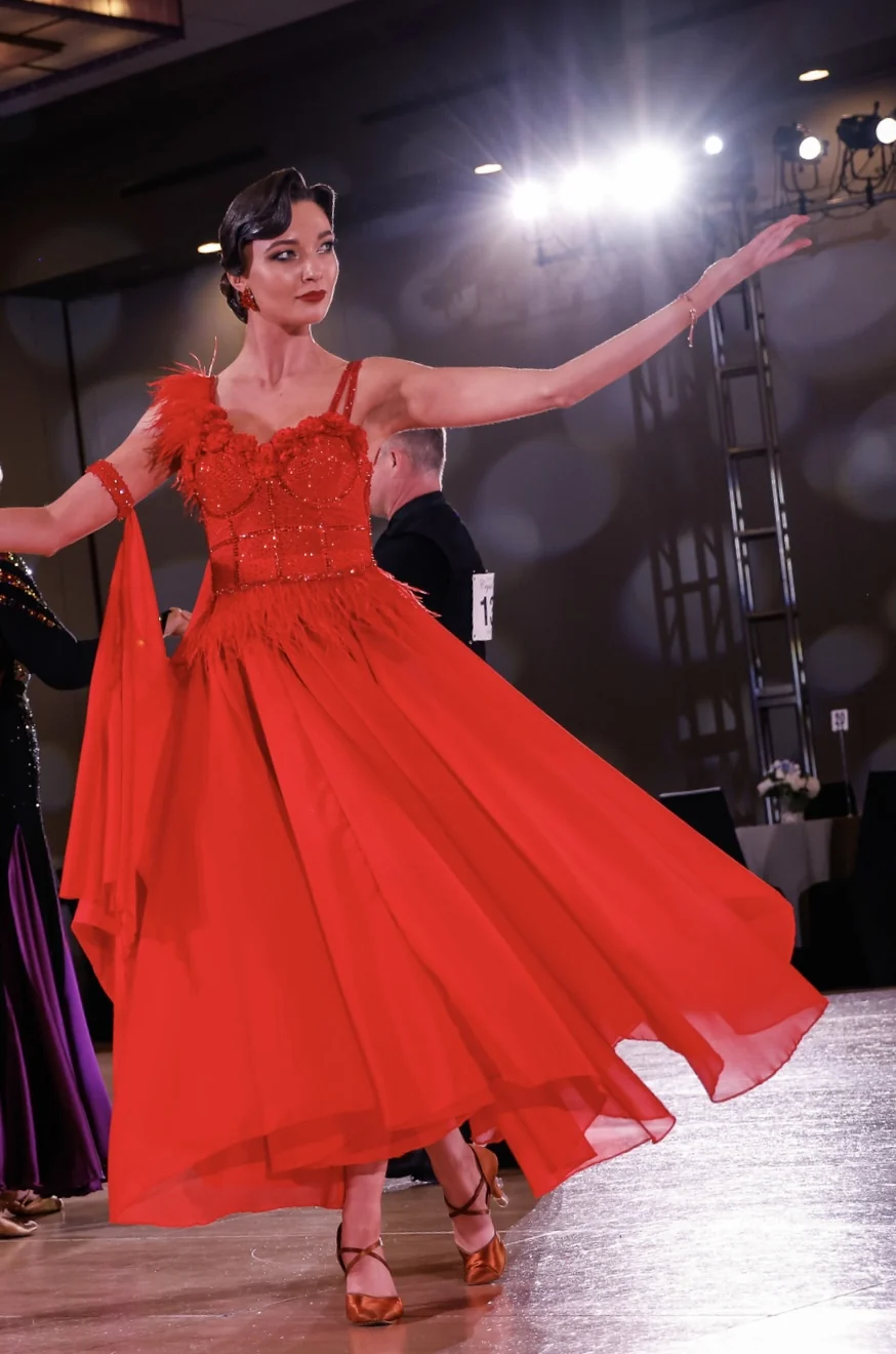 Ballroom dancer performing in a red gown